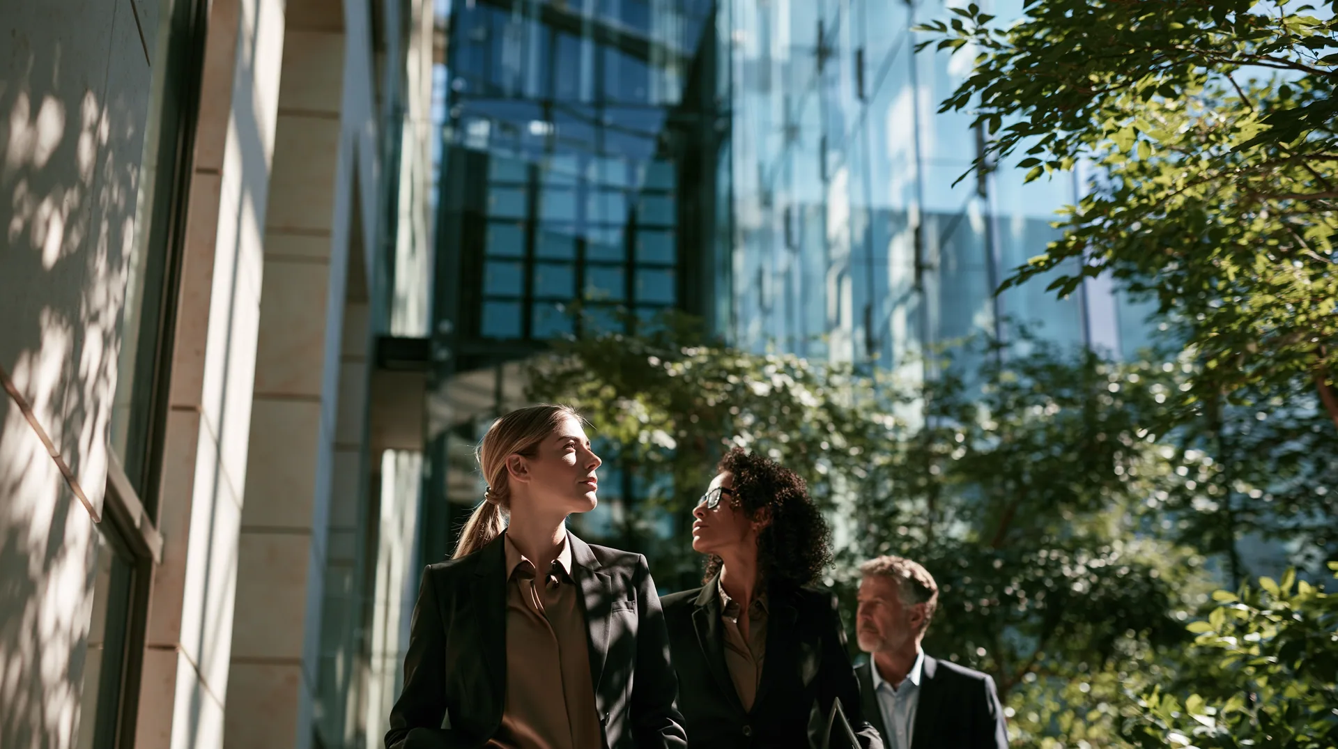 Illustration: three executives walking past a glass office building