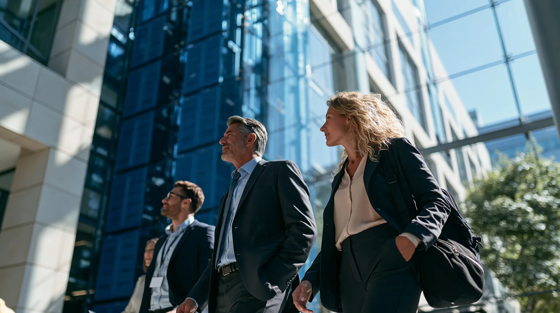 Illustration: three executives walking past a glass office building