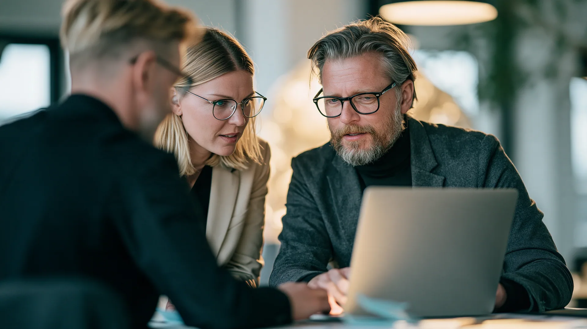 Illustration: two colleagues working through figures at a laptop